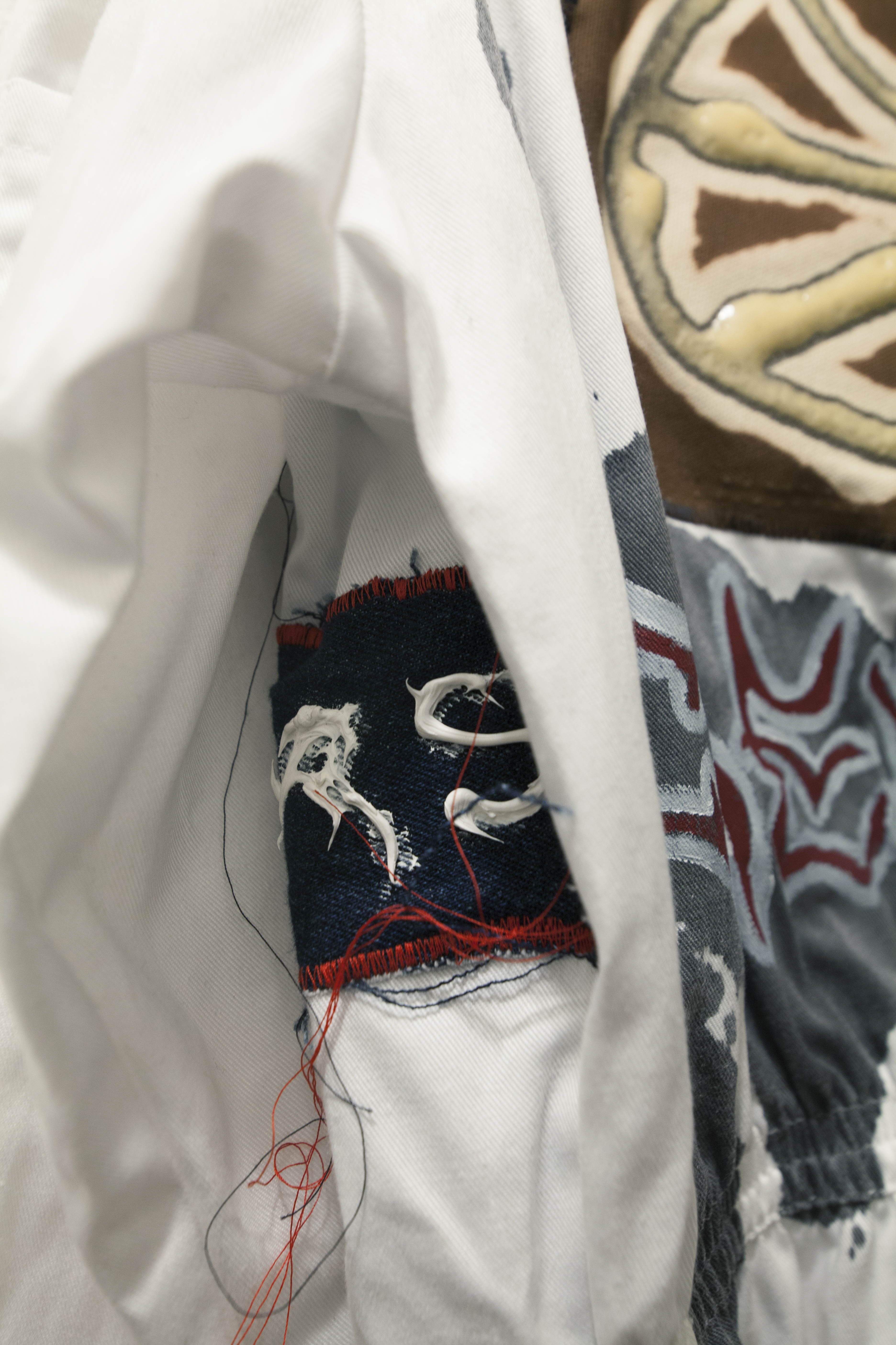 Detail of a patch swen onto a white jumpsuit
